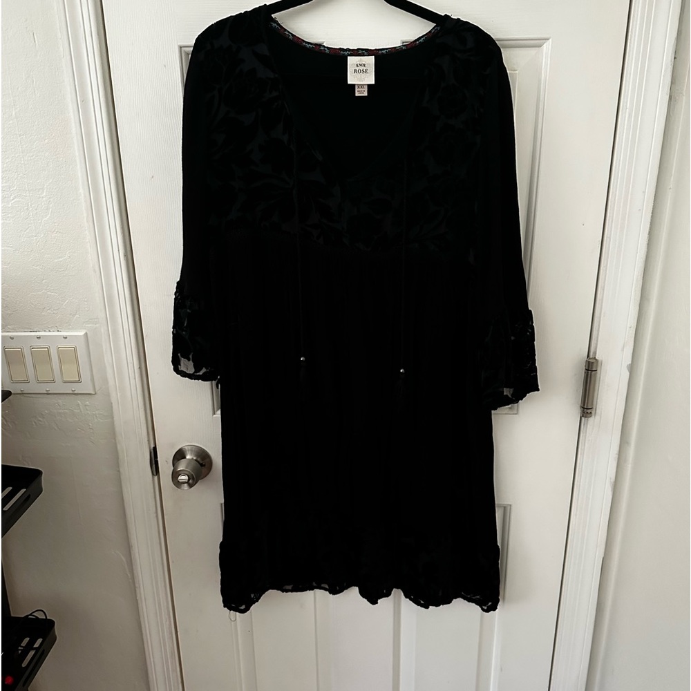 Black dress with flower and ruffle detail